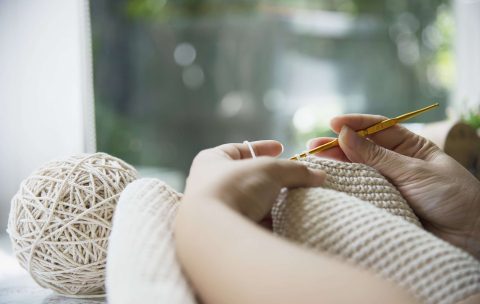 woman-s-hands-doing-home-knitting-work-min-scaled