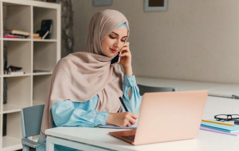 young-pretty-modern-muslim-woman-hijab-working-laptop-office-room-education-online-1-scaled